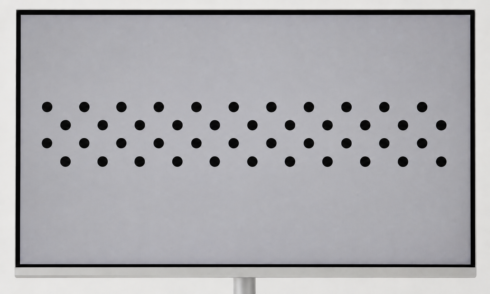 Flat monitor displaying a full-screen asymmetric circle grid calibration pattern